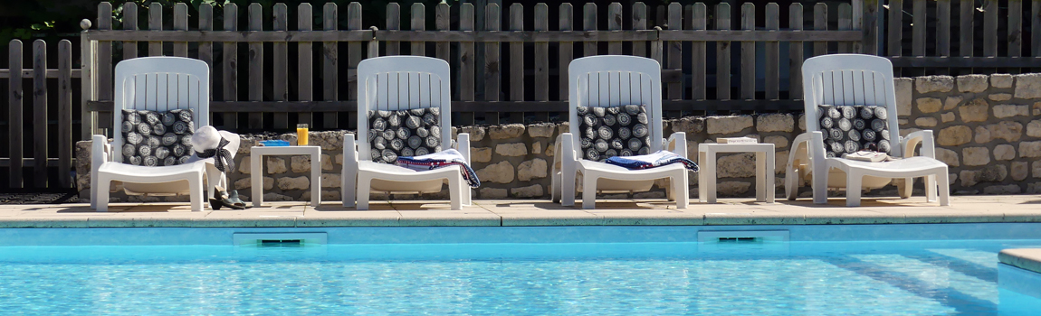 Relax by the pool at Maison Lairoux Holiday Cottages